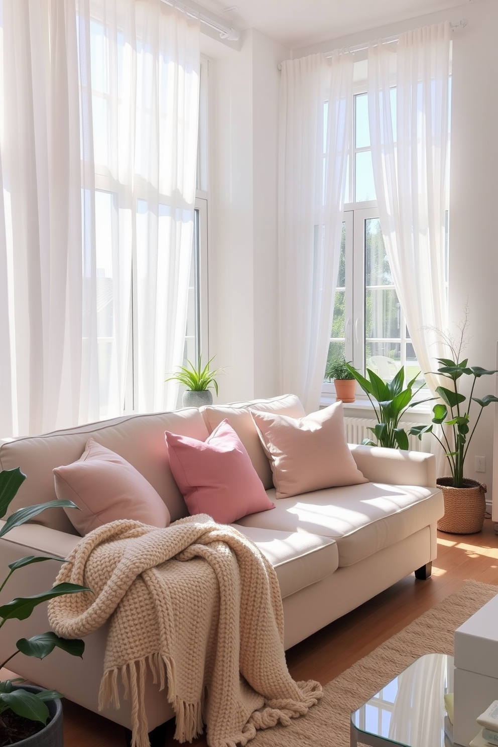 A bright and airy summer apartment filled with natural light. The living room features light sheer curtains draping elegantly over large windows, allowing sunlight to filter through softly. The space is adorned with pastel-colored throw pillows and a cozy, textured throw blanket on a light-colored sofa. Potted plants are strategically placed around the room, adding a touch of greenery and freshness.