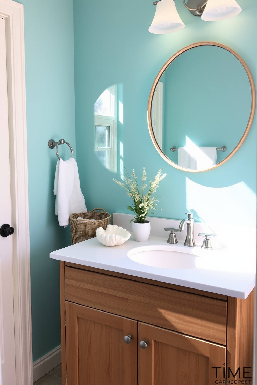 A bright and cheerful bathroom setting inspired by the beach. The walls are painted in a soft aqua blue, and sandy beige accents create a warm atmosphere. A stylish wooden vanity with a white quartz countertop features a fun beach-themed soap dispenser shaped like a seashell. Above the vanity, a round mirror with a driftwood frame reflects the natural light streaming in from a nearby window.