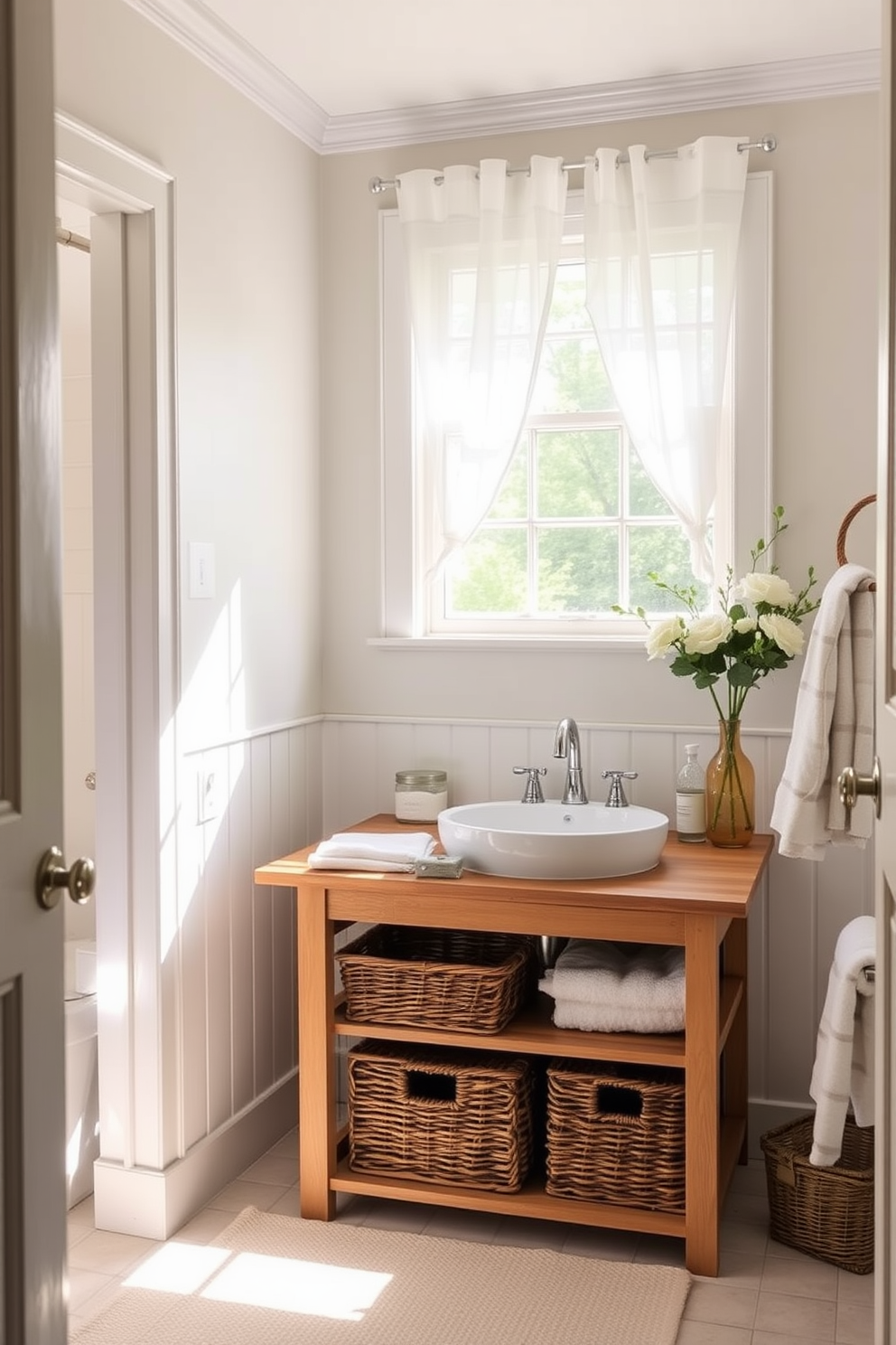 A bright and airy summer bathroom features wicker baskets neatly arranged under a wooden vanity for stylish storage. The walls are painted in a soft pastel color, and natural light floods the space through a large window adorned with sheer white curtains.