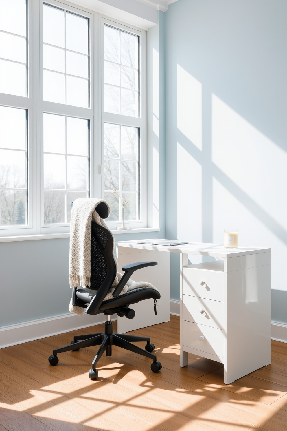 A bright and airy home office space with large windows allowing natural light to flood in. The walls are painted in a soft pastel blue, complemented by a sleek white desk with a minimalist design. A comfortable ergonomic chair is positioned at the desk, adorned with a cozy throw blanket. A refreshing scented candle sits on the desk, adding a touch of warmth and inviting aroma to the space.