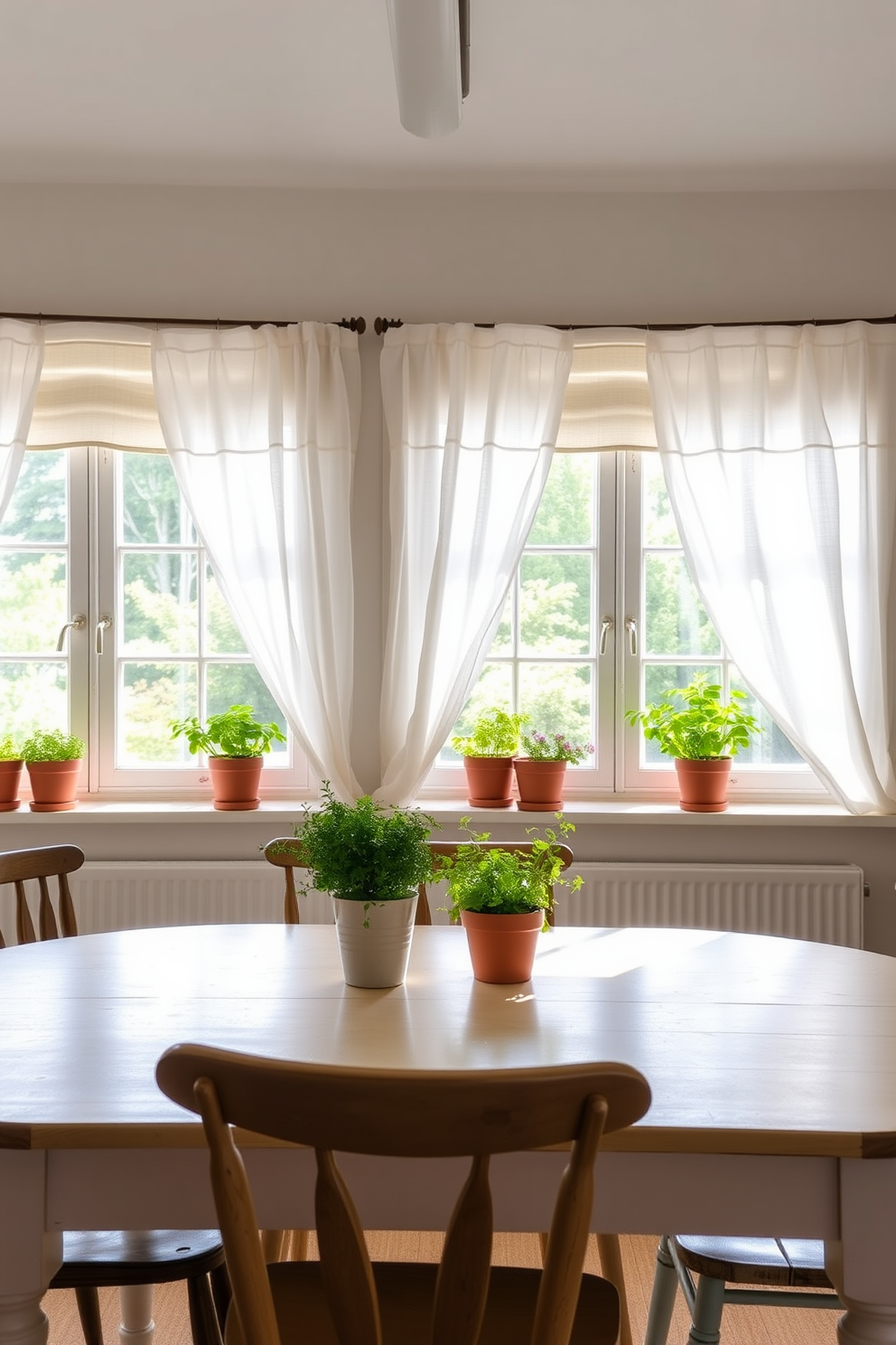 A bright and inviting summer kitchen filled with natural light. The windows are adorned with light and airy white linen curtains that gently sway in the breeze. A large farmhouse table is centered in the room, surrounded by mismatched wooden chairs. Fresh herbs in terracotta pots are placed on the windowsill, adding a touch of greenery and warmth.