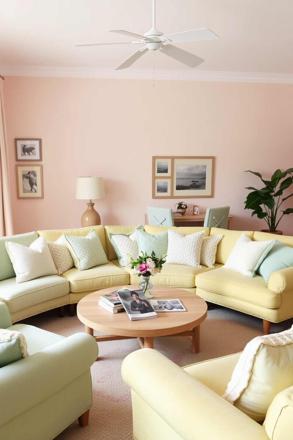 A serene summer living room filled with soft pastel colors. The walls are painted in a light blush pink, and the furniture features a mix of mint green and pale yellow upholstery. A large, comfortable sectional sofa is adorned with various textured throw pillows in complementary pastel shades. A round coffee table made of light wood sits in the center, topped with a few stylish magazines and a small vase of fresh flowers.