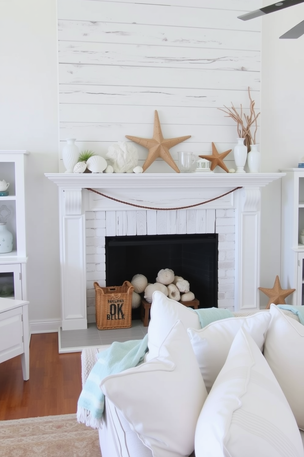 A bright and airy living room featuring a whitewashed wood mantel adorned with coastal-themed decorations. Seashells, starfish, and driftwood accents create a beachy vibe, while a light blue throw and soft white pillows add a touch of summer comfort.