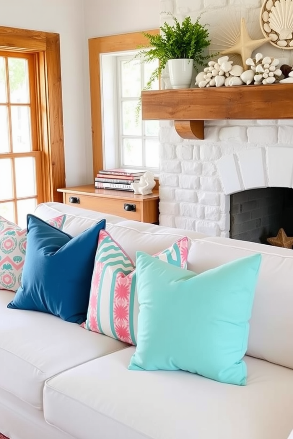 Bright throw pillows in various colors and patterns are scattered across a plush white sofa, creating a cozy and inviting atmosphere. The vibrant hues of the pillows contrast beautifully with the neutral tones of the sofa, adding a pop of color to the living space. For summer mantel decorating ideas, a collection of seashells and coastal-themed decor is arranged on a rustic wooden mantel. Fresh greenery in a simple vase complements the seasonal theme, while soft, natural light filters through nearby windows, enhancing the warm ambiance.