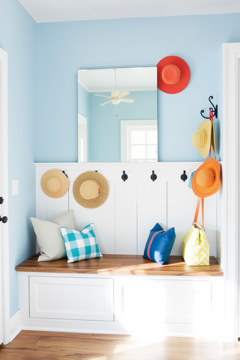 A bright and inviting mudroom features a rustic bench with built-in storage underneath. A large, frameless mirror hangs above the bench to enhance light and create the illusion of more space. The walls are painted in a soft, airy blue, complemented by white shiplap accents. Decorative hooks line the wall, showcasing colorful summer hats and bags for a cheerful touch.