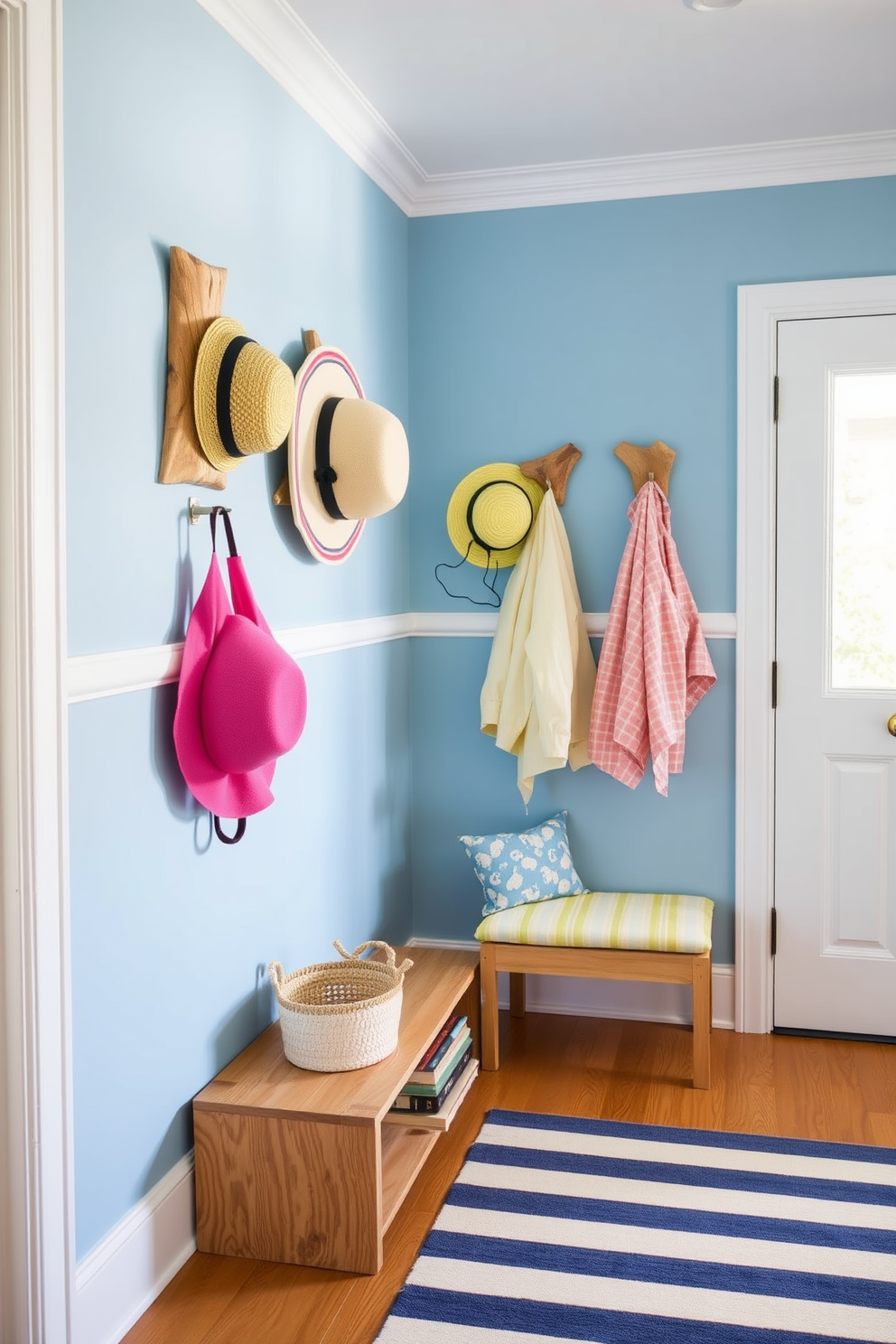 A charming summer mudroom features decorative hooks made of natural wood, each displaying vibrant summer hats and lightweight jackets. The walls are painted in a soft coastal blue, and the floor is adorned with a cheerful striped rug that adds a playful touch.