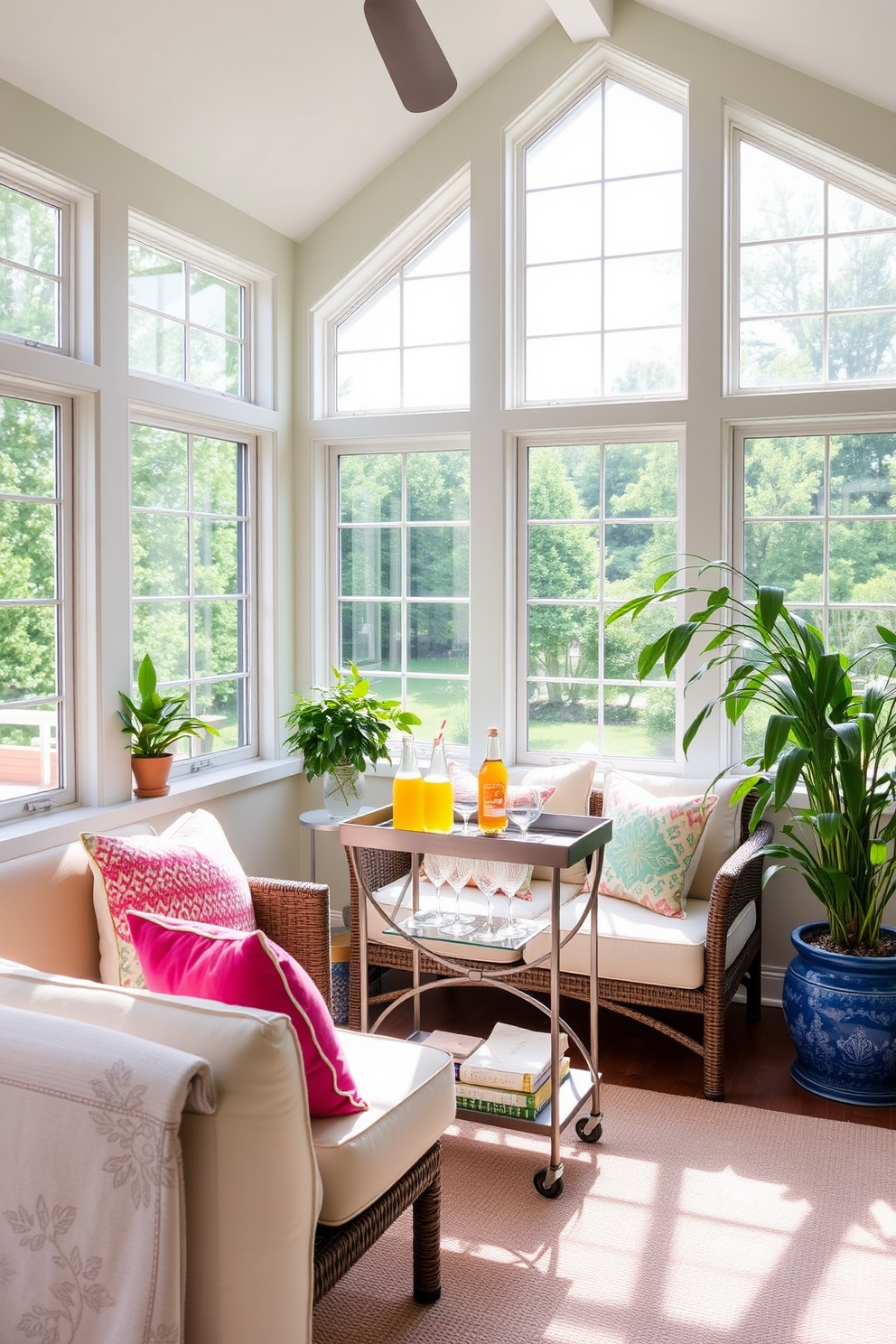 A bright and inviting summer sunroom features large windows that allow natural light to flood the space. Comfortable seating is arranged around a small bar cart, which is stocked with colorful beverages and glassware for entertaining guests. The walls are painted a soft pastel color, enhancing the cheerful atmosphere of the room. Lush greenery in decorative pots adds a touch of nature, while vibrant throw pillows and a light area rug create a cozy and stylish environment.